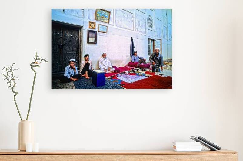 People sitting on carpeted floor in Khiva Uzbekistan by Marco Brivio