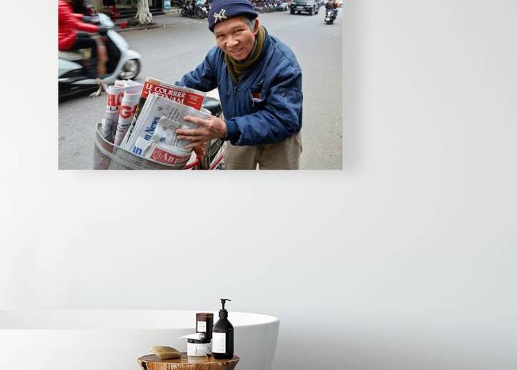 Man selling newspapers in Ho Chi Minh City by Marco Brivio