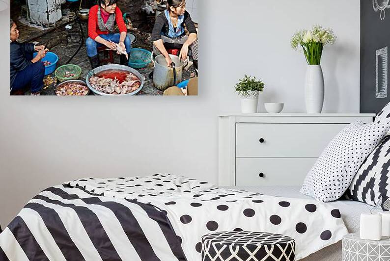 Women preparing fish in a market in Hanoi Vietnam by Marco Brivio