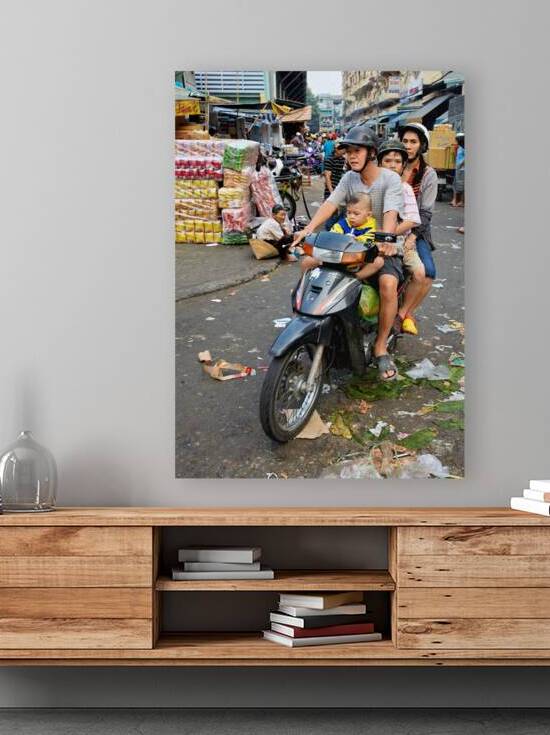 Motorbike family ride through busy Ho Chi Minh street in Vietnam by Marco Brivio