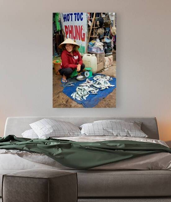 Woman selling fish at a market in Phu Quoc Vietnam by Marco Brivio