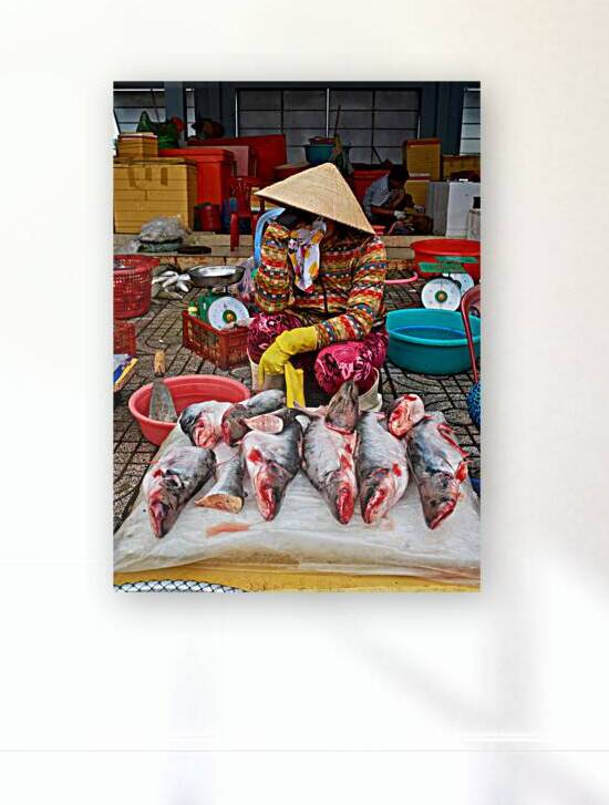 Woman selling fish at market in Phu Quoc Vietnam by Marco Brivio