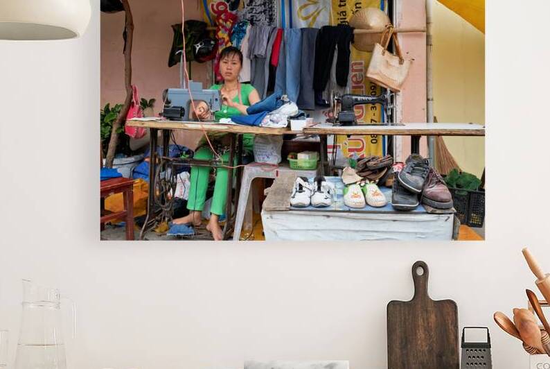 Sewing clothes at a market stall in Phu Quoc Vietnam by Marco Brivio