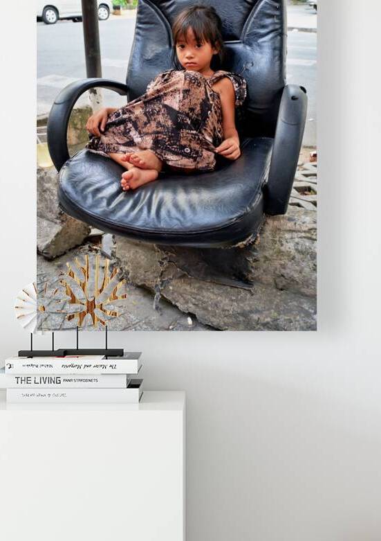 Child sitting in chair on street in Ho Chi Minh City by Marco Brivio