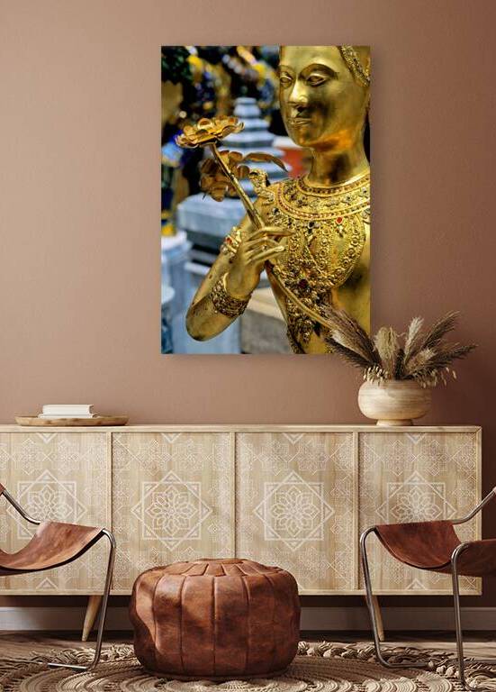 Golden statue holding flower at Wat Phra Kaew in Bangkok by Marco Brivio