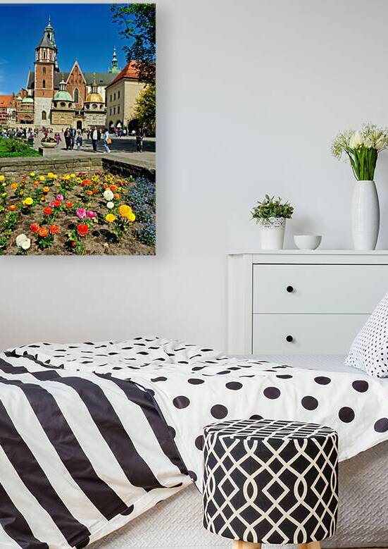 People walk in Krakow with flowers and buildings around by Marco Brivio