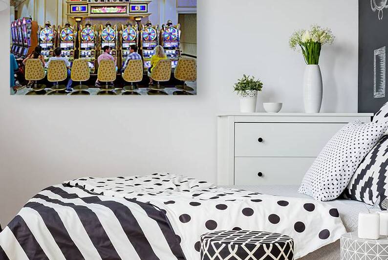 People play slot machines at Venetian Hotel in Las Vegas by Marco Brivio