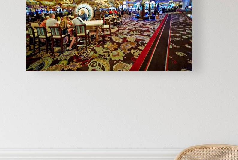 Visitors play slot machines at Bellagio Casino in Las Vegas by Marco Brivio